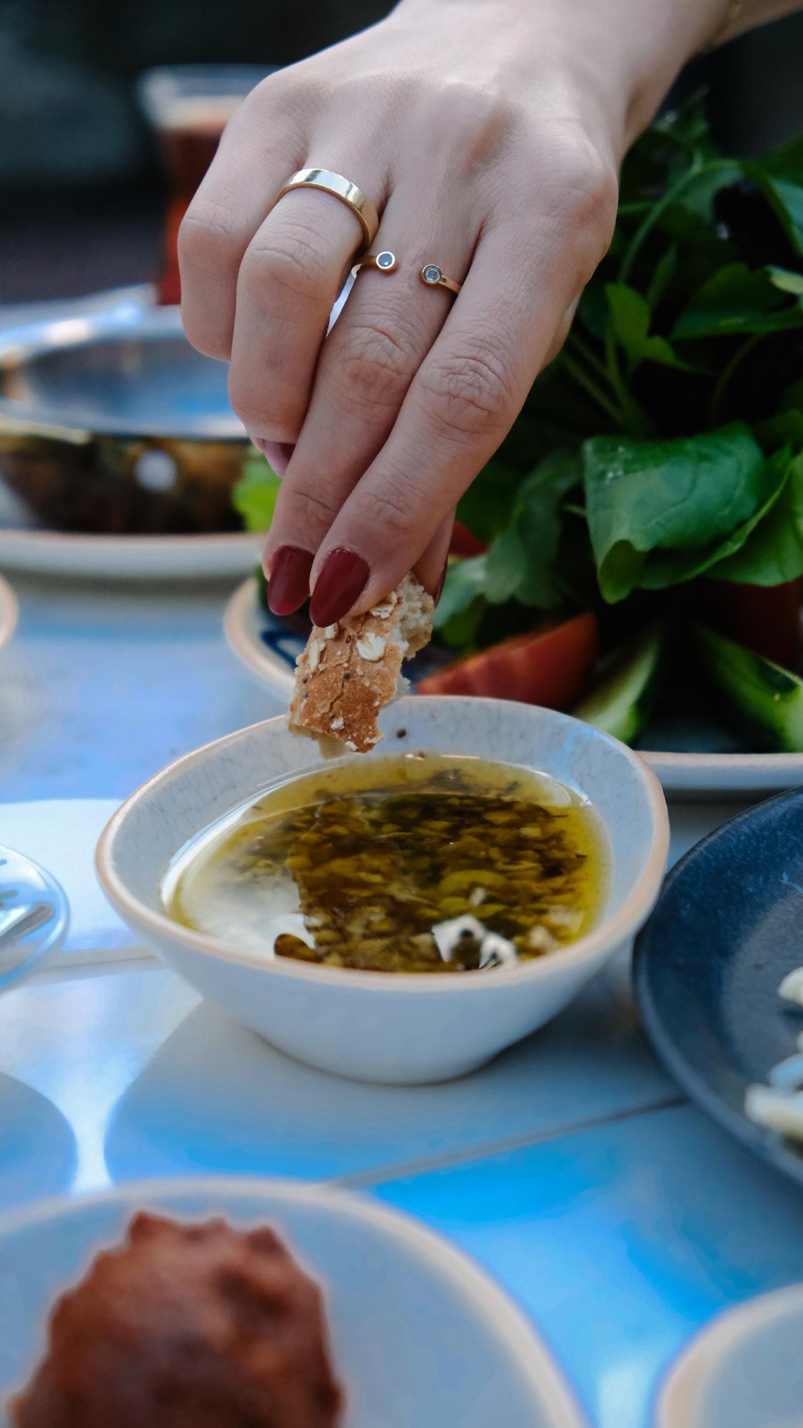 Close-up of hands seasoning a dish